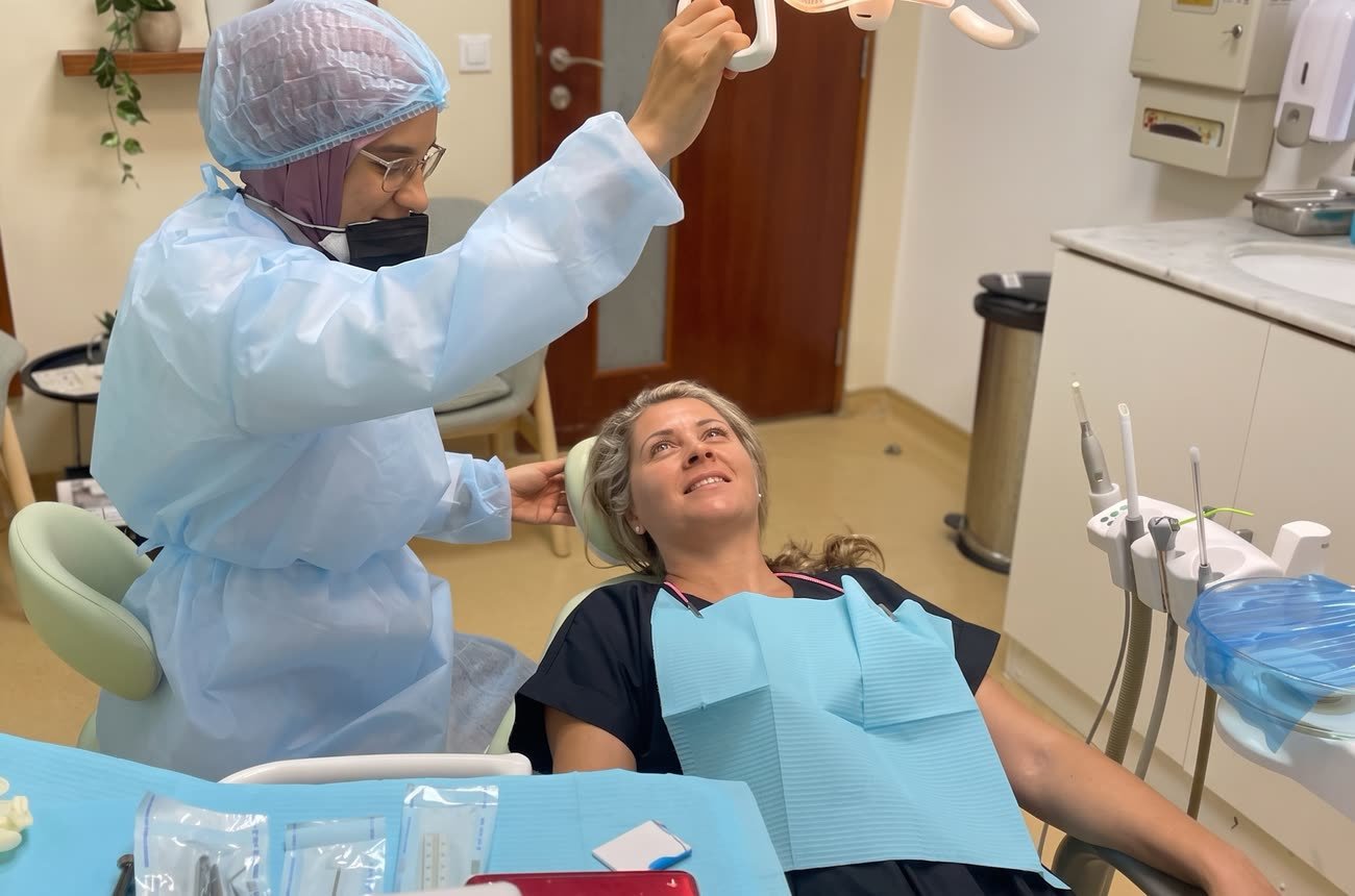 Dr. Doaa Bedewy adjusting the light before treating a patient in her Dubai clinic